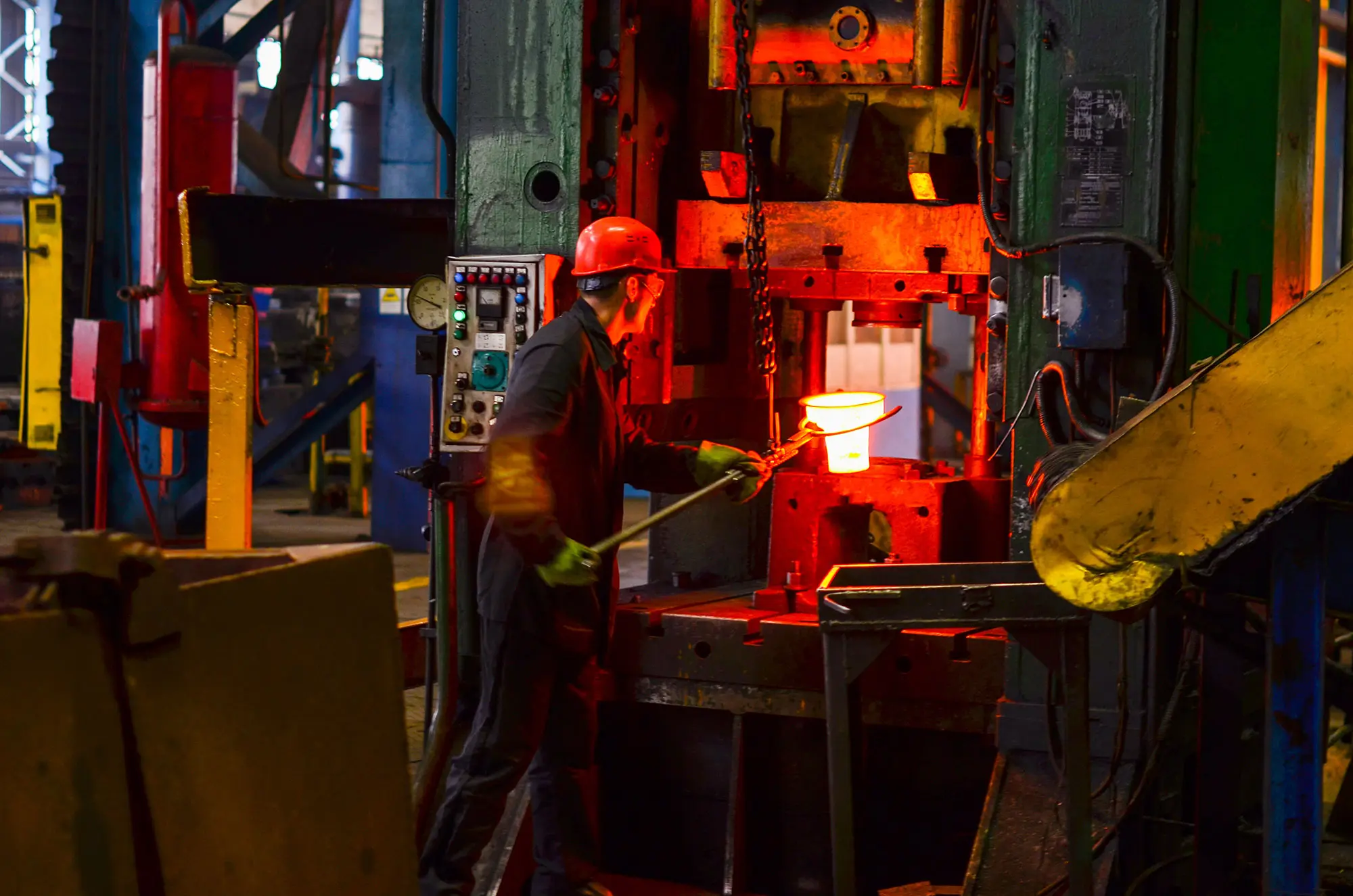 Hot iron in smeltery held by a worker. High precision hot forging product, automotive part production by hot forging process, automatice line hot forging. iron melting recycling work.